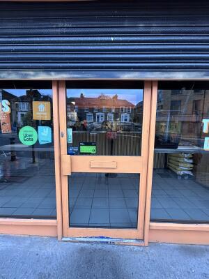 Glass door with orange frames ahead. Push from left to open.