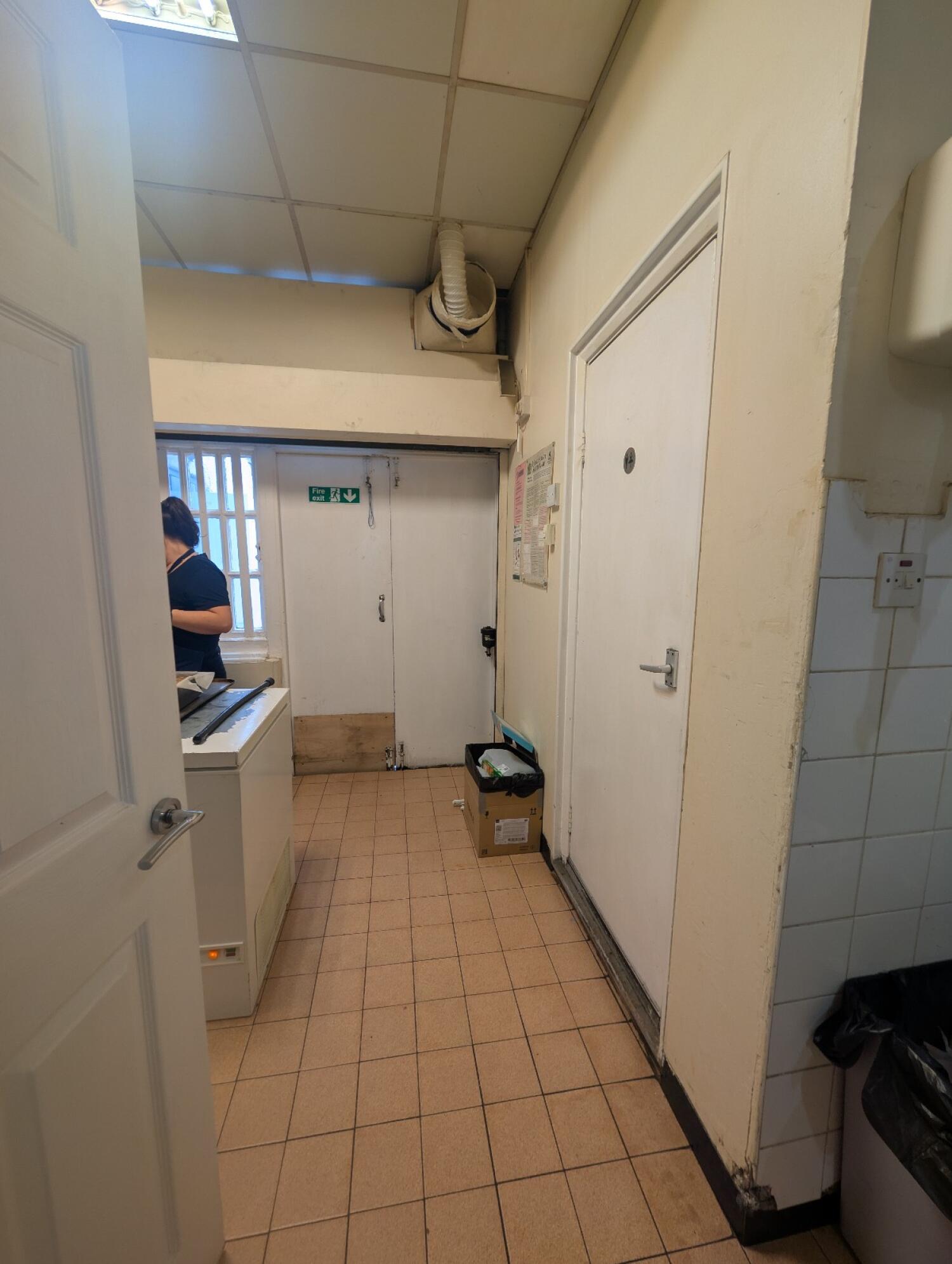 From preceding door facing straight. Staff area on left and back. Bathroom door on right.