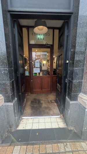 Black wooden doors. Push in center to open