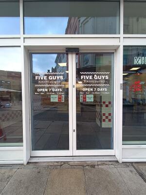 Glass door with white frame. Opens from middle.