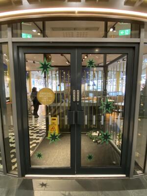 Black framed glass door. Pull black metal handle from centre to open.
