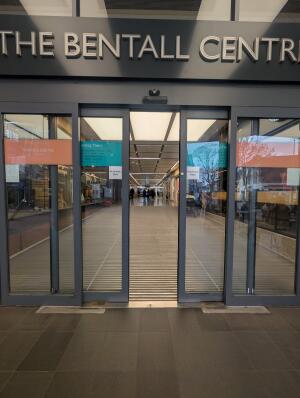 Grey frame glass doors in front. Doors automatically open to sides.