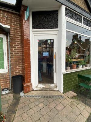 White framed glass door. Push silver metal long handle from right to open.