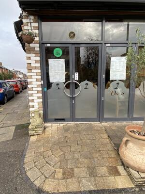 Grey framed glass door. Pull silver metal handle from centre to open.