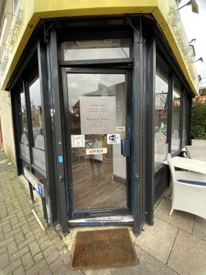 Black framed glass door. Push from right to open.