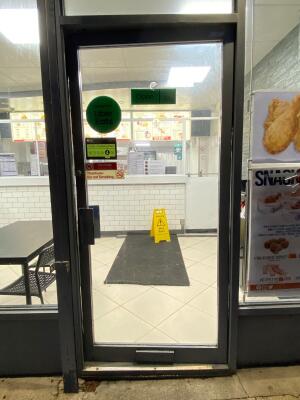 Grey frame glass doors in front. Metal handle on left. Push to open.
