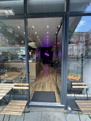 Black framed glass door ahead. Push door from left to open inwards.
