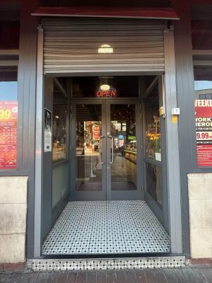 Archway with a grey frame ahead with one step at entrance.