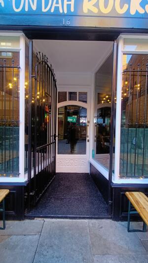 Metal door to venue. Push handle on right to open.