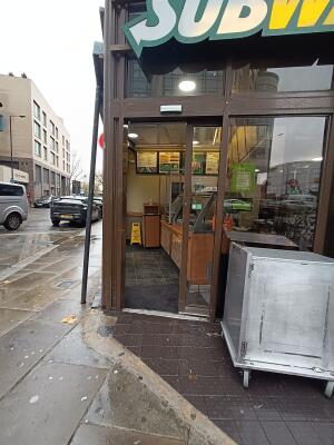 Brown metal-framed glass door. Slide door from left to right to open.