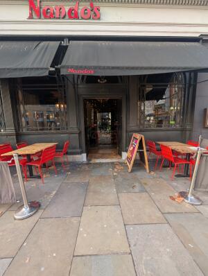 From street facing venue. Fencing on both sides in front. Archway in center at back.