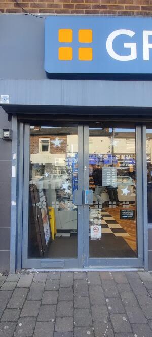Grey-frames glass doors with handles in center, pull to open.