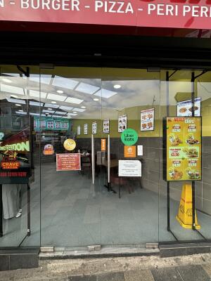 Glass doors ahead. Push handles in centre to open.