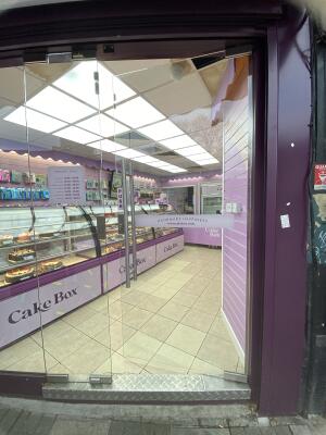 Glass door. Push silver metal handle from left to open.