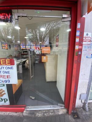 Glass door. Push silver metal handle from left to open.