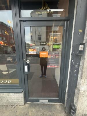Black framed glass door ahead. Push from left to open.