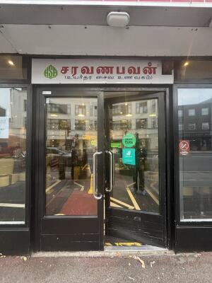 Black framed glass doors ahead. Push from centre to open.