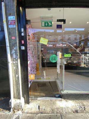 Glass door. Push silver metal handle from right to open.