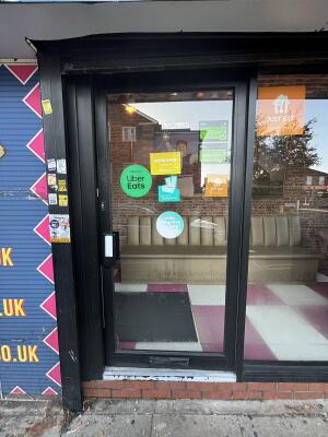 Black framed glass door ahead. Push from left to open.