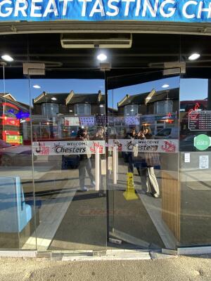 Glass door. Push silver metal handle from centre to open.