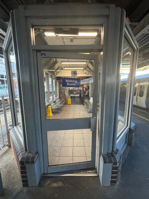 White framed glass door. Push white metal handle from right to open.