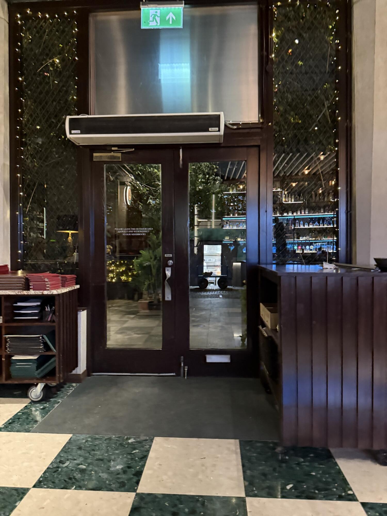 Dark wood-framed glass door. Pull from handle on right to open.