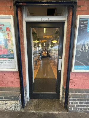 Black-framed glass door. Push from right to open.