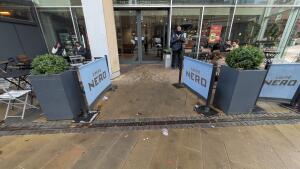From street facing venue. Path ahead. Fencing on both sides.