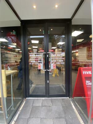 Black framed glass door. Pull silver metal handle from centre open.