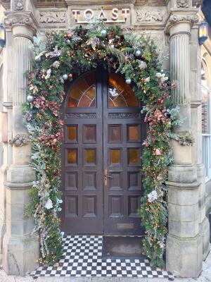 Brown wooden door ahead. Push from handle at centre to open.
