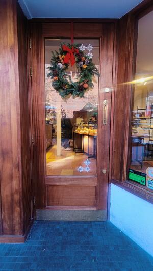 Glass panelled wooden door. Pull handle on right to open.