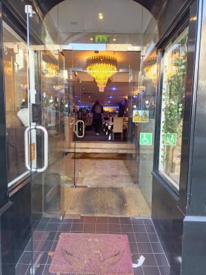 Open archway ahead to glass door on back. Pull from handle on right to open.