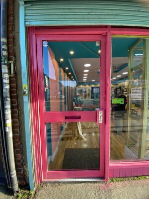 Pink framed glass door. Push from right to open.