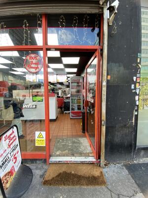 Orange framed glass door. Push from left to open.