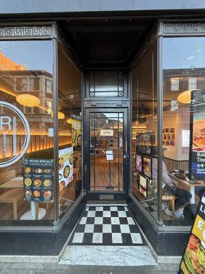 Open archway ahead to black-framed glass door on back. Pull from handle on right to open.