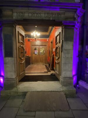 Yellow wooden door ahead. Press door bell on right side of door and wait for staff coming to open.