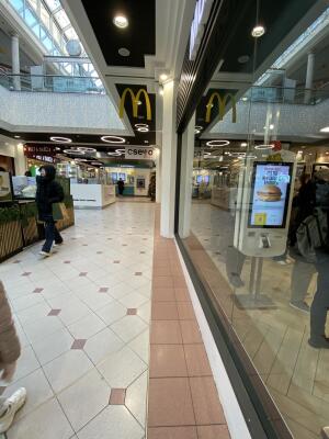 From main entrance facing left. Pathway to alternative entrance ahead. Glass wall on right.
