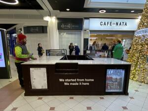 From complex facing venue. Payment counter in center. Food display along its sides.