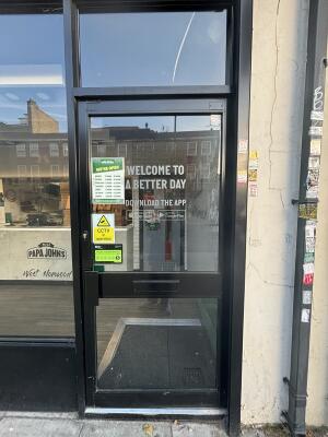 Black framed glass door ahead. Push from left to open.