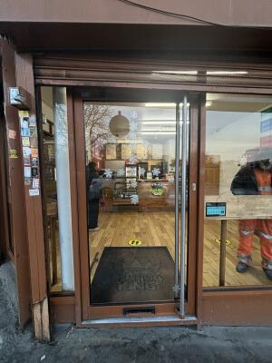 Brown glass door ahead. Push handle on right to open.