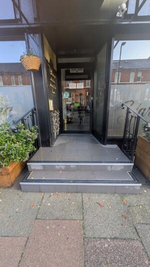 From street facing venue. Two steps up before door. Handrails on both sides