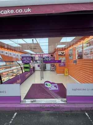 Glass doors with metal handles at centre. Push right door from handle on left to open.