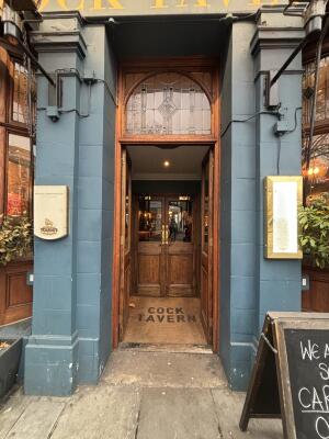 Brown wooden doors with glass panels ahead. Push from handles at centre to open.