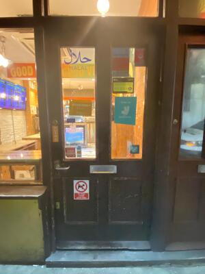 Black wooden glass door ahead. Push from left to open.