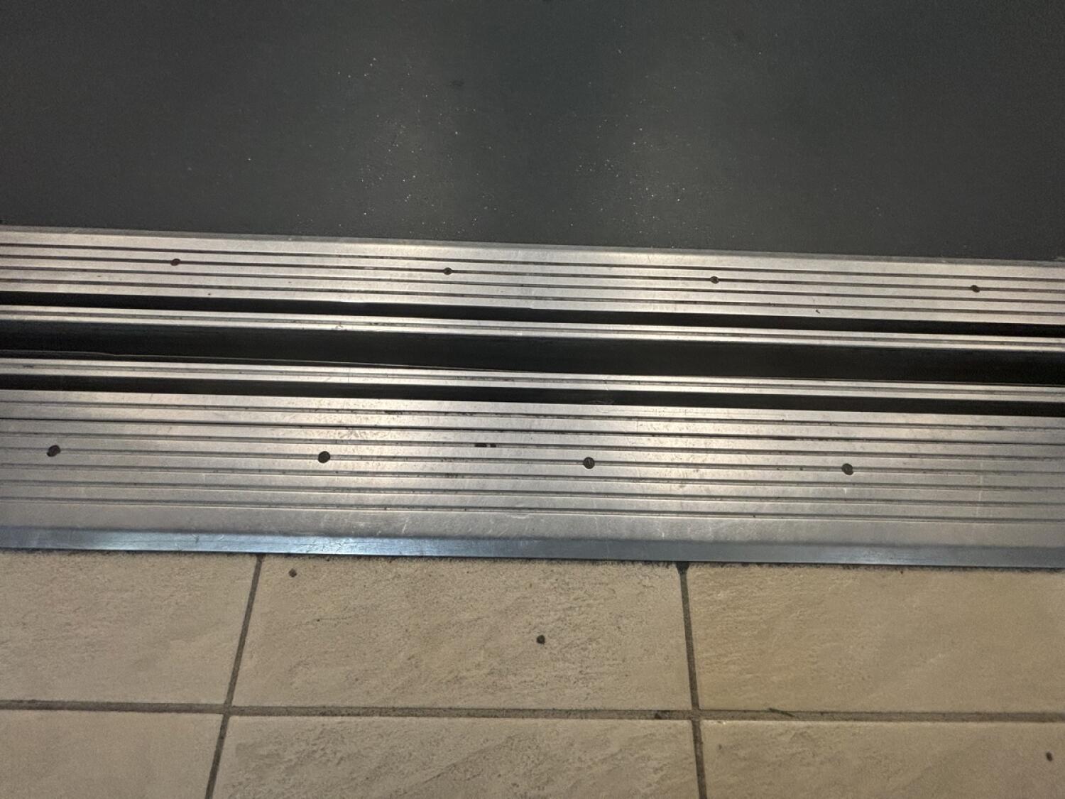 Metal ridge at foot of lift door.