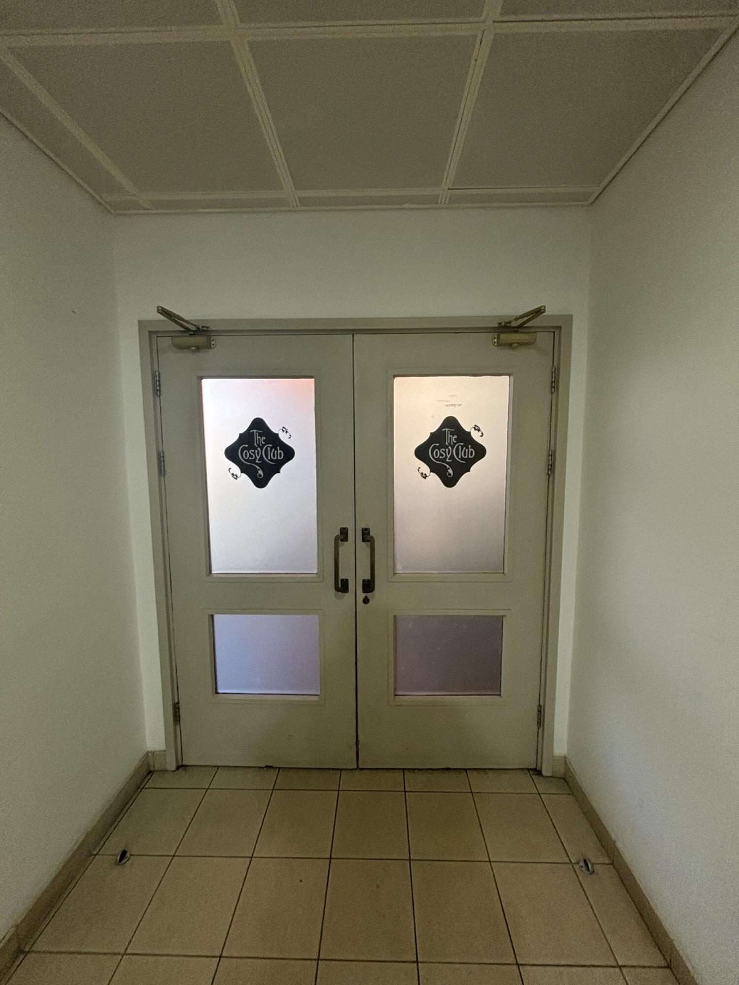 From outside of lift facing left. Wooden framed glass doors ahead. Pull from centre to open.