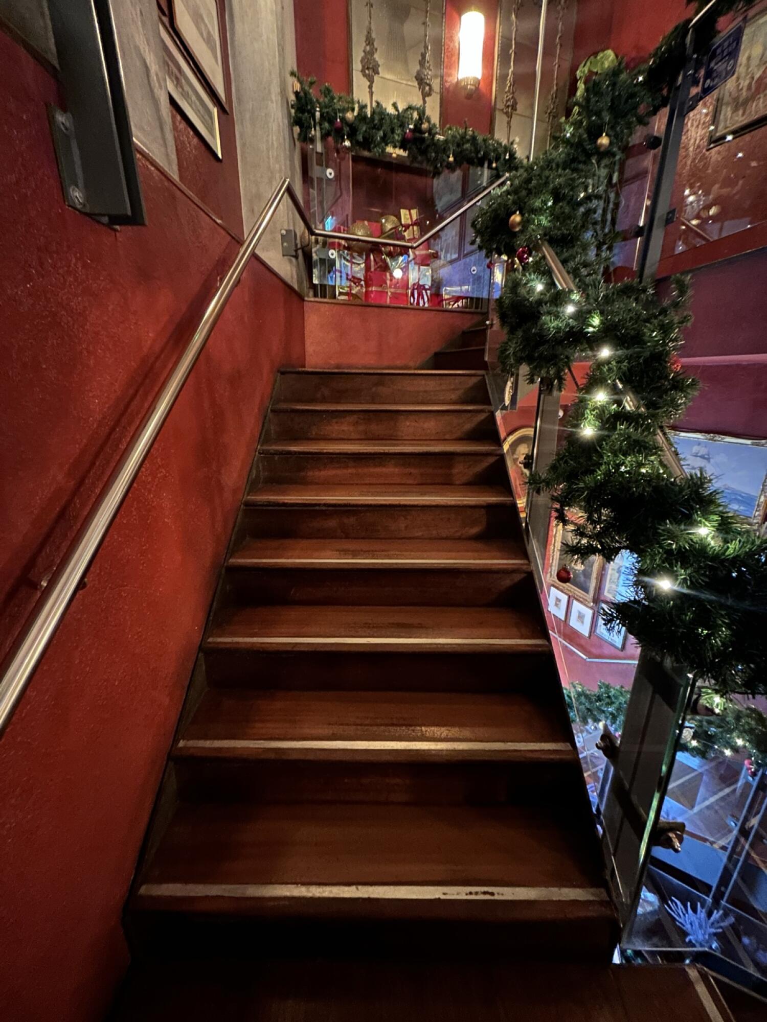 From landing area facing right. Wooden stairs continue going up. Hand-rail on both sides.