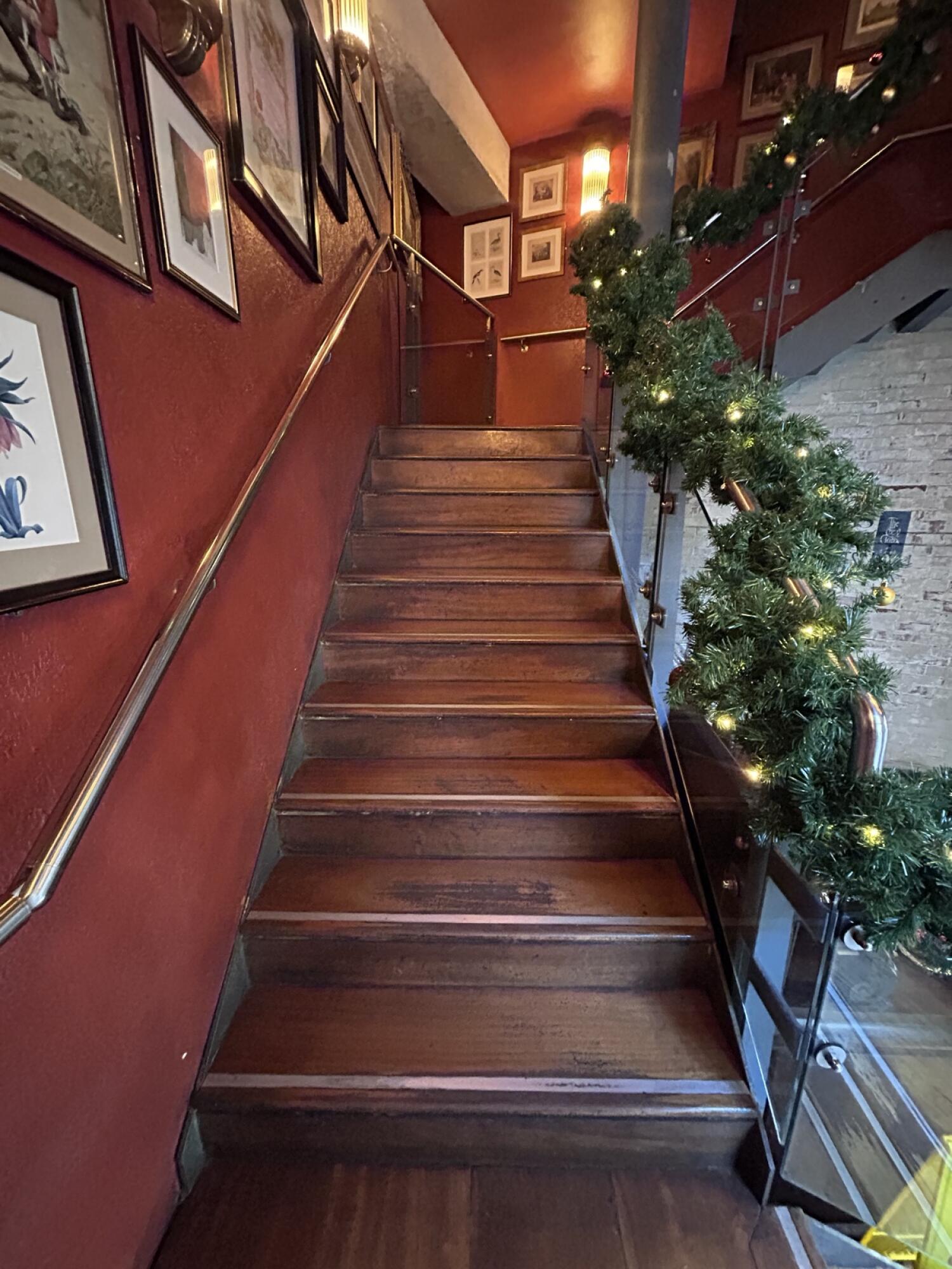 From landing facing right. Wooden stairs continue going up. Hand-rail on both sides.