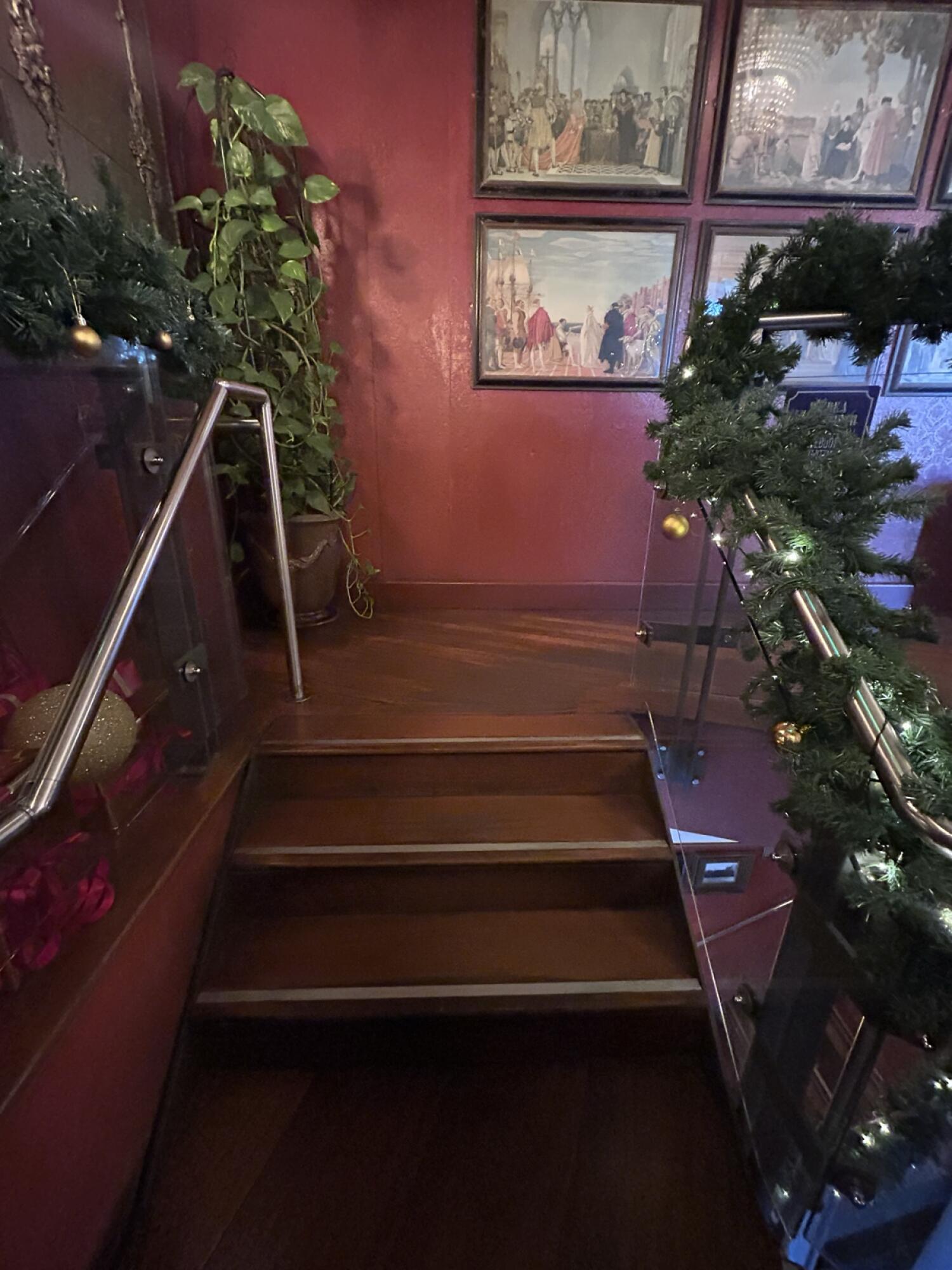 From landing facing right. Wooden stairs continue going up. Hand-rail on both sides.