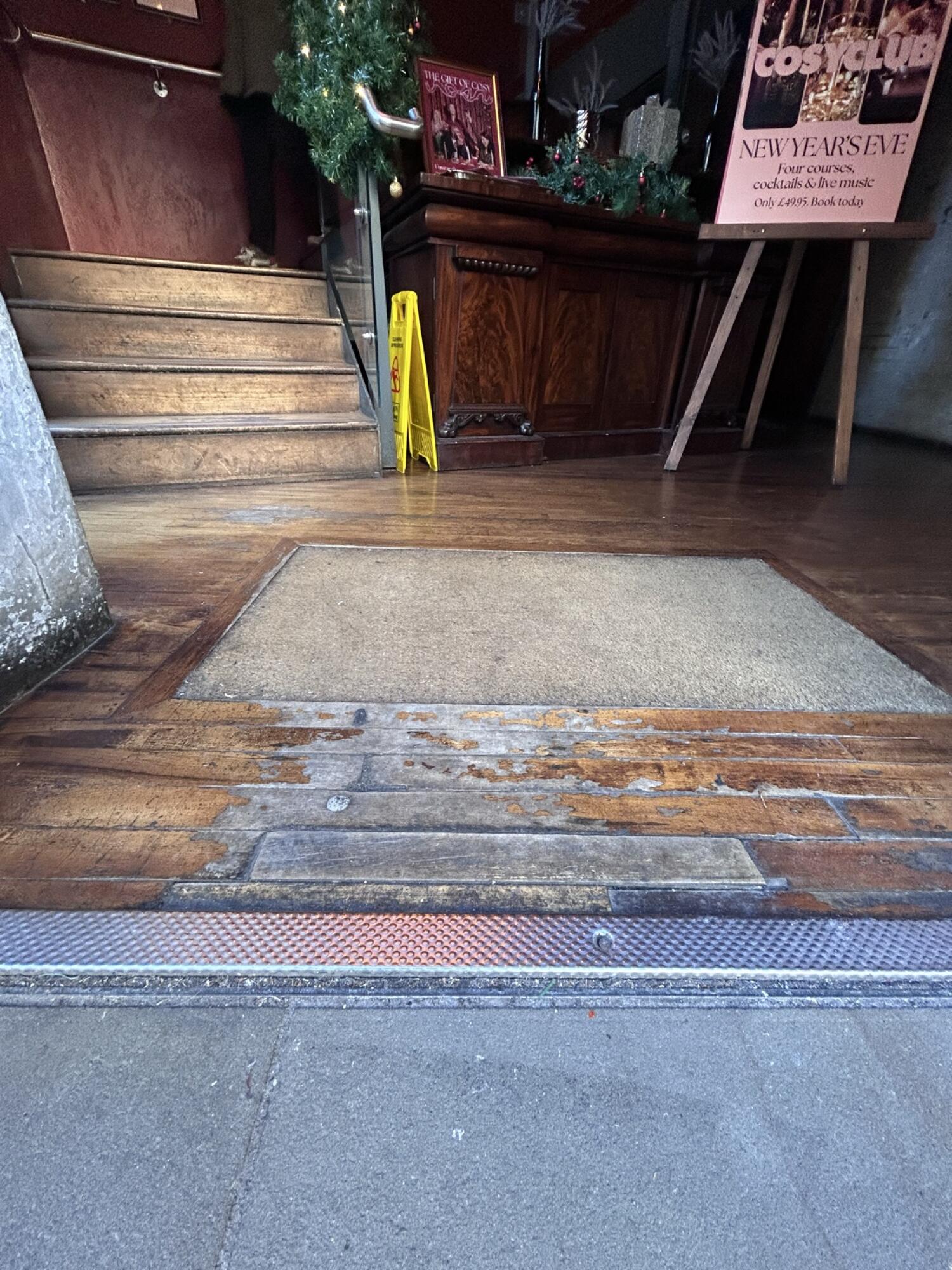 Raised edge at foot of door. Small bump ahead.